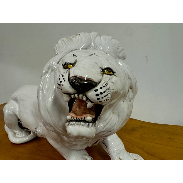 This striking ceramic sculpture depicts a majestic lion in a fierce, roaring pose. Crafted with meticulous attention to...