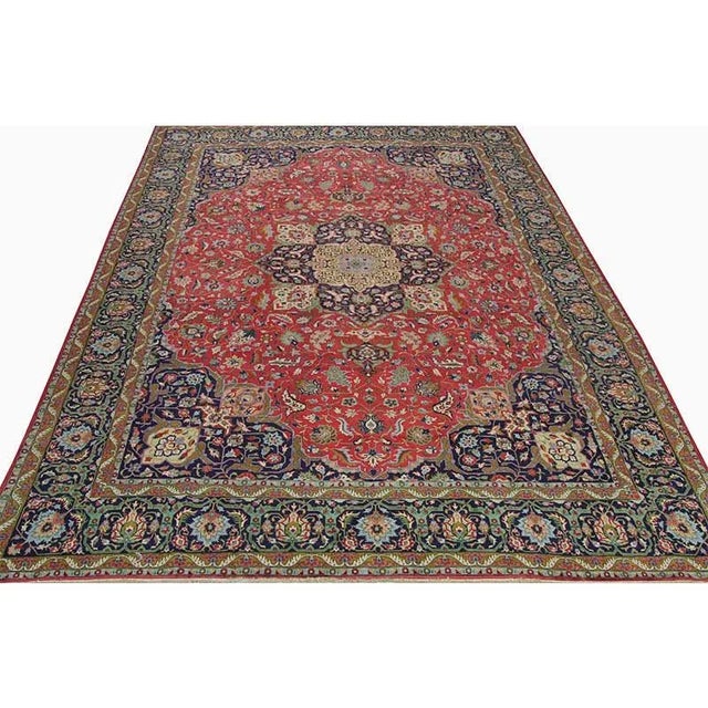 ACTUAL SIZE: 9’10” x 13’7″ PRIMARY COLOR: Red / Navy AGE: Old MATERIALS: Wool FOUNDATION: Cotton PRODUCTION: Handwoven,...