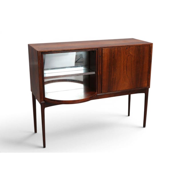 An exceptional and rare 1960s Norwegian rosewood bar cabinet by Sola Møbelfabrik with a standout feature — a full...