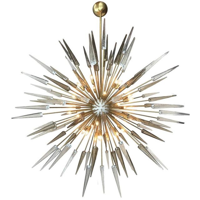 Italian modern sputnik chandelier with clear and smoky Murano glass shards spikes, mounted on natural unlacquered brass...