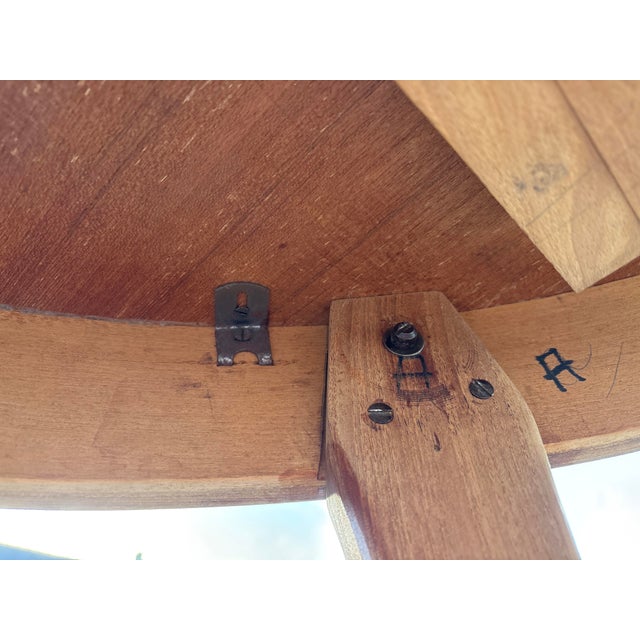 Elegant vintage round dining table crafted in solid teak, dating from the 1960s and inspired by Scandinavian modern...