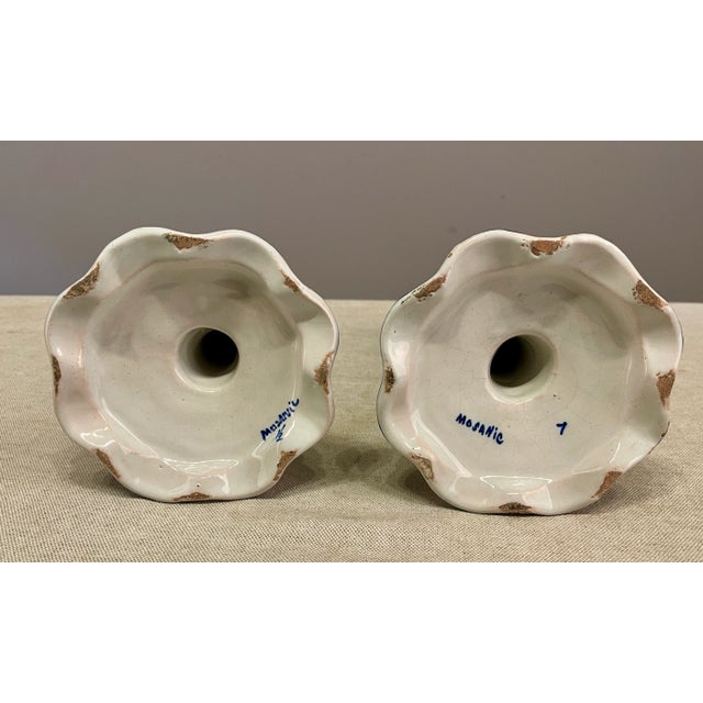 An early 20th pair of French Faience Candlestick with the Rouen Decor, from the faiencerie of Desvres, signed on bottom...