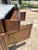 An elegant Louis XVI style commode featuring a warm wood finish with a white marble top. The piece showcases clean lines,...