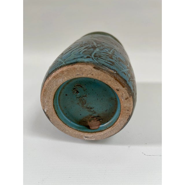 Beautifully detailed Midcentury modern hand-made blue pottery vase with an abstract designed exterior. Maker's mark on...