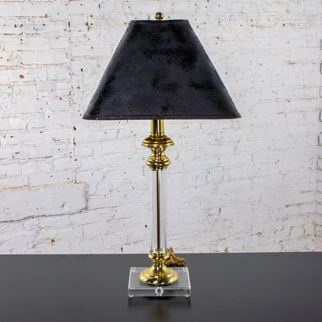 Stunning vintage Neoclassic Revival candlestick table lamp composed of Lucite with brass details, 3-way switch, and square...