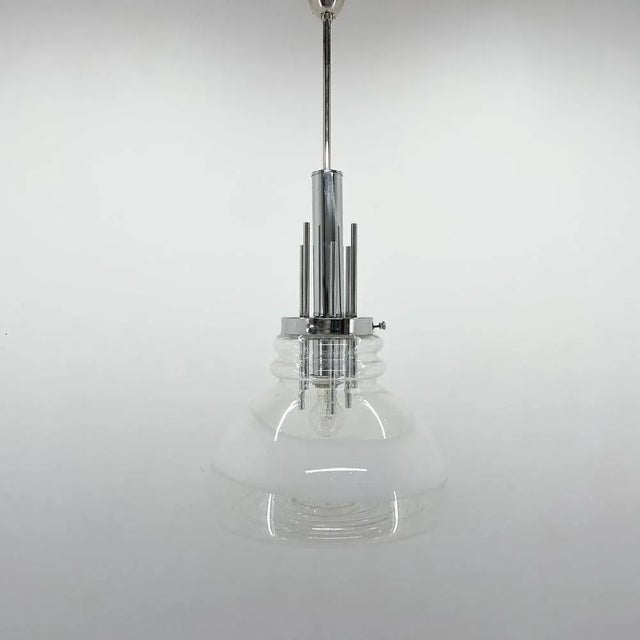 Mid-century Italian pendant light by Mazzega. Made from Murano glass and chrome. Bulb: 1 x E25-E27. This piece is...