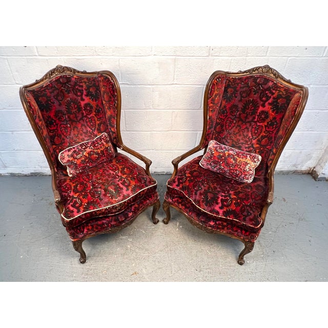 This elegant pair of French bergère chairs, crafted in the style of Louis XV, features graceful lines, carved details, and...