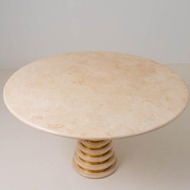 Sculptural pedestal dining table crafted from solid travertine and brass, attributed to Italian designer Marzio Cecchi for...