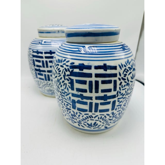 These images depict a pair of traditional Chinese ginger jars, often used for decorative purposes or storage of tea,...