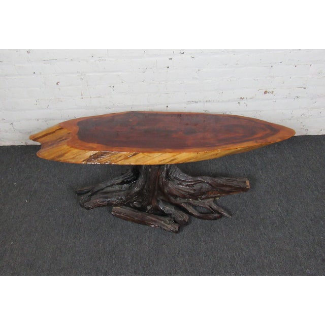 This unique side table has a live edge tree round surface held up by a tree root base. Perfect for bringing a small piece...