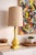 Vintage Mid Century Modern table lamp featuring a glossy yellow ceramic base with a sculptural silhouette and a warm...