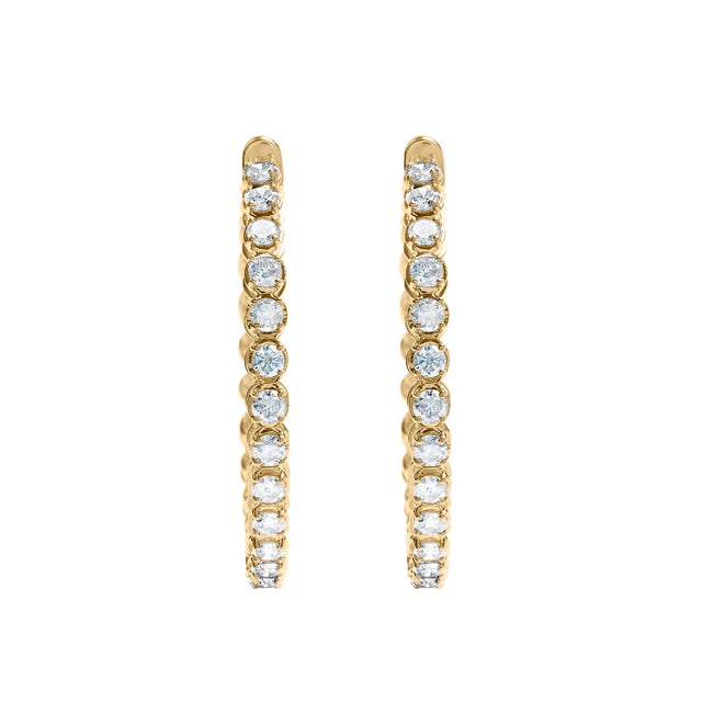 Immerse yourself in the opulence of these enchanting hoop earrings, meticulously crafted from lustrous 14K yellow gold....