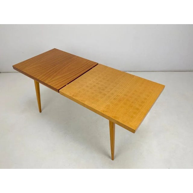 Vintage two-tone coffee table from former Czechoslovakia. The top is in glossy finish.