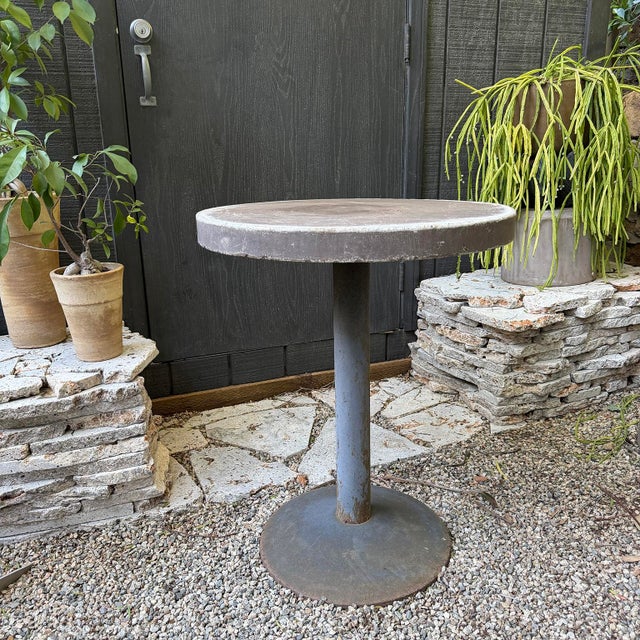 20th century brutalist cafe table with concrete top and steel base. Suitable for outdoor use.