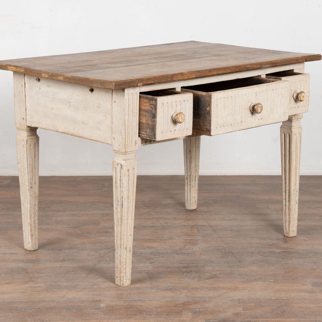 19th century Swedish side table or console, crafted in pine and retaining its original painted finish. The base is...
