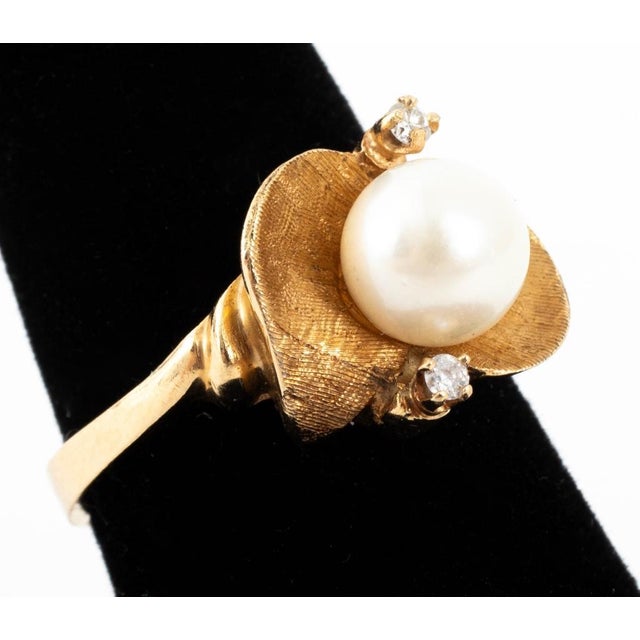 18K Yellow Gold Pearl Diamond Ring, featuring one round cultured pearl approx. 7.0-7.5 mm, flanked by two round brilliant...