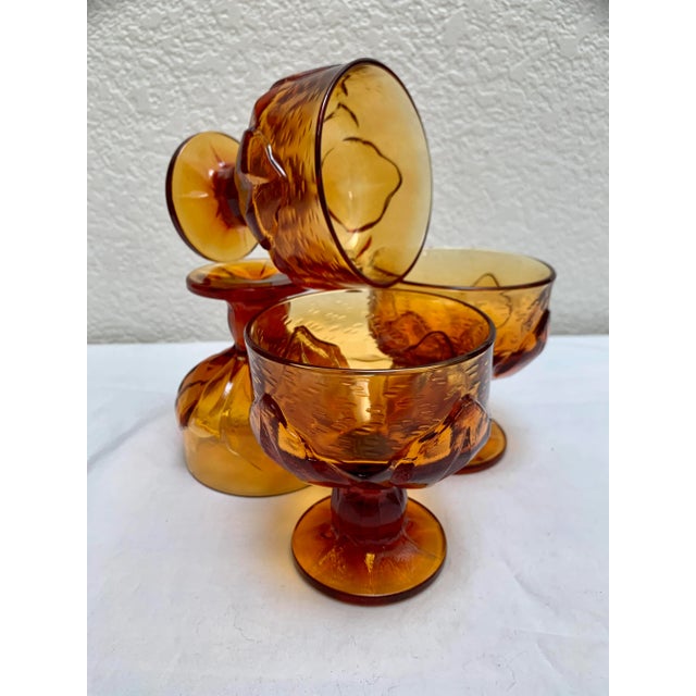 Midcentury set of four textured goblets with floral leaf textured pattern. Solid substantial glass in a deep rich amber or...