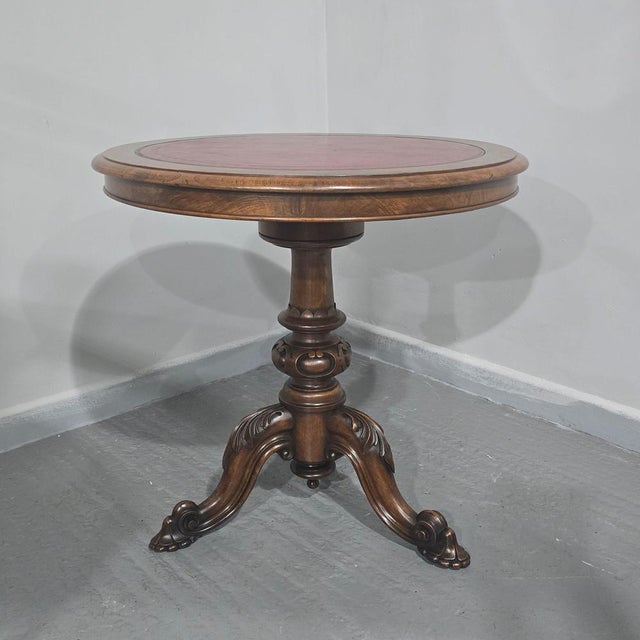 A rare Victorian walnut and burr walnut swivel top library table with inset red leather, in excellent overall condition....