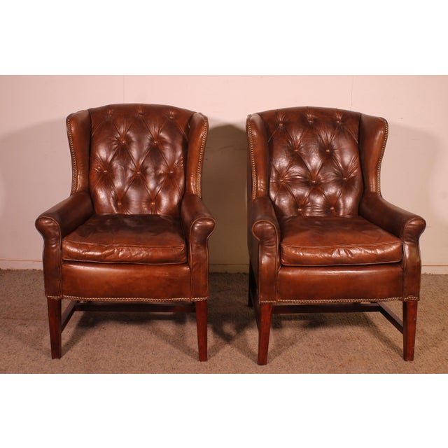 A superb pair of brown leather wingback Chesterfield armchairs A very beautiful and elegant design with a stunning...