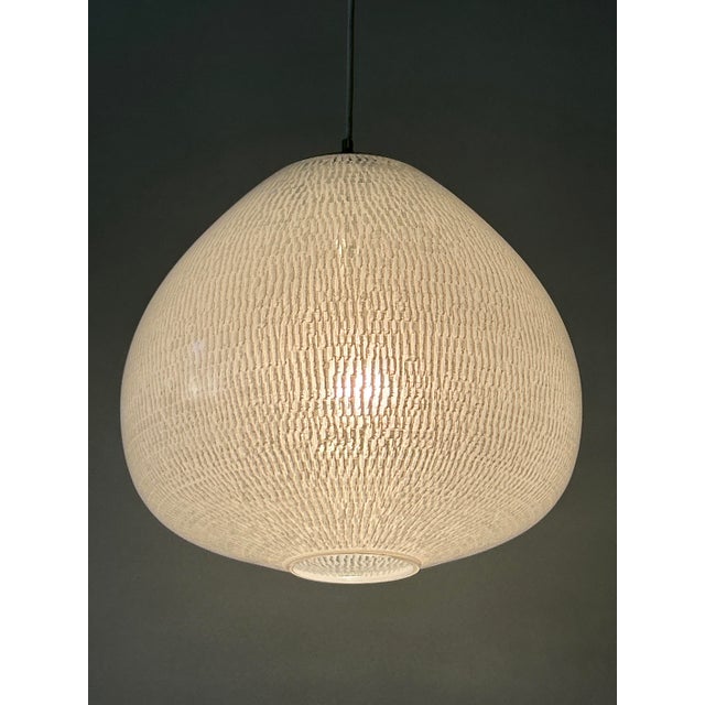 Extremely rare, elegant and highly decorative mid-century modern pendant lamp or hanging light. Designed probably by...
