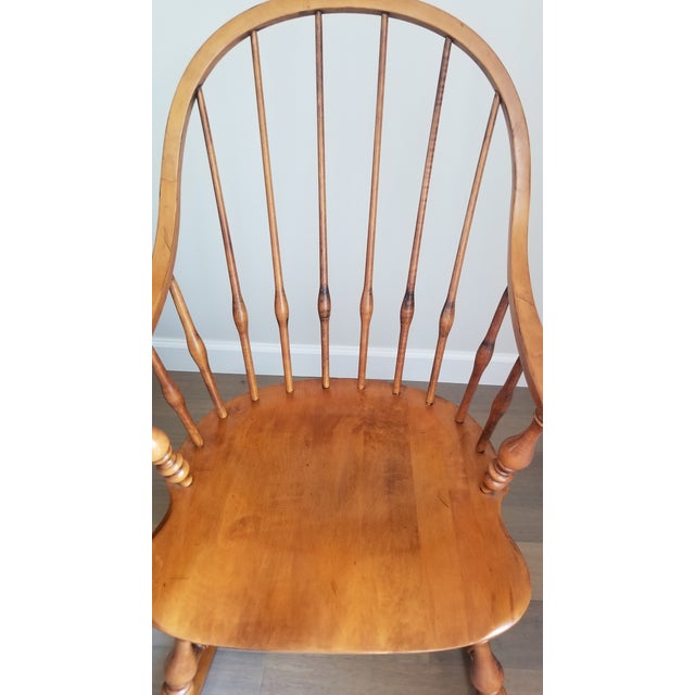 This vintage Ethan Allen rocking chair is a stunning piece of furniture that will add elegance to any room. The chair is...