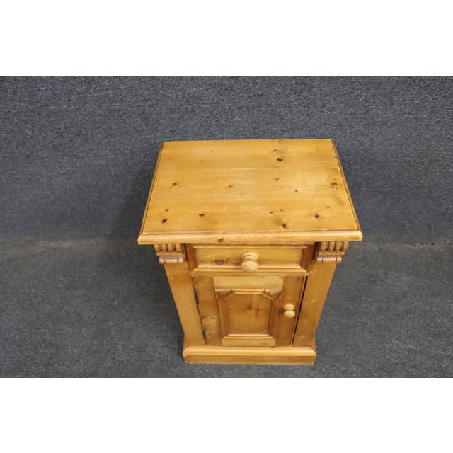 Charming antique Scandinavian pine cabinet featuring a single dovetailed drawer above a paneled cupboard door opening to a...