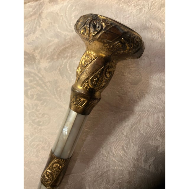 Magnifying glass made with handle of early 1900s ornate walking stick with mother of pearl and brass and gold ormolu. Has...