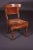 Biedermeier chair, circa 1845. Solid wood with red cover. Rear legs saber-shaped. Wide curving backrest.