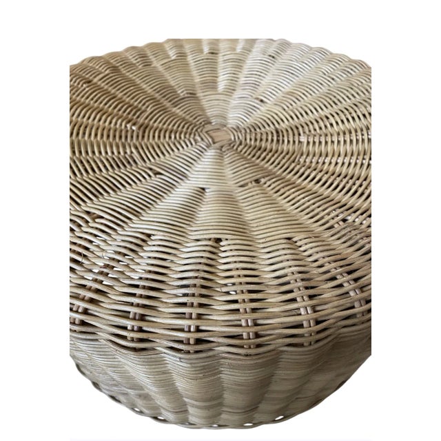 1950's round wicker footstool. Natural woven wicker with tapered wood legs. Researched time period.