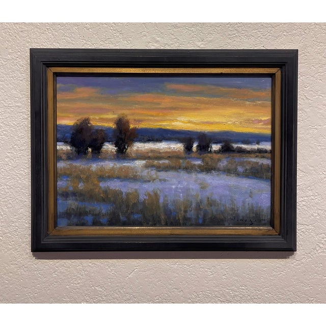 This oil painting captures a tranquil landscape at dusk, where the sky transitions into a warm palette of oranges and...