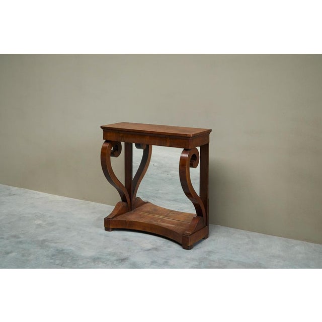 Dutch empire console table with integrated mirror early 19th century a mahogany empire console table with integrated...