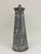 Vintage galvanized metal pitcher with a tapered body, flared spout, and long loop handle. The weathered galvanized finish...
