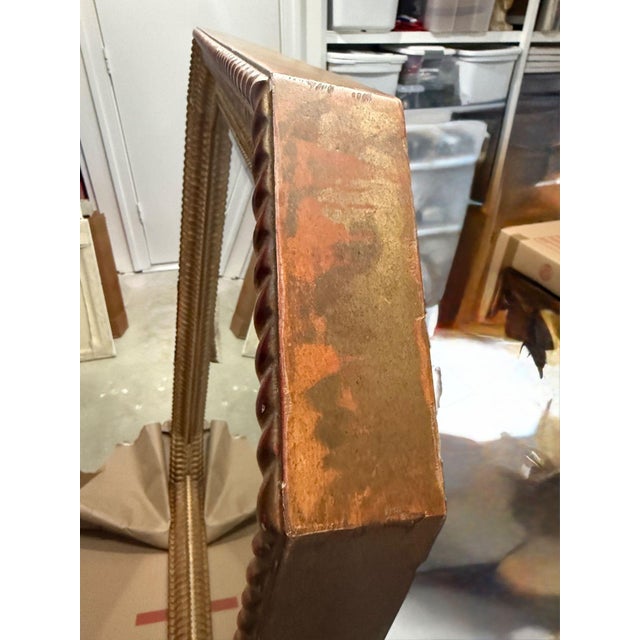 Very Large Gold Leaf Rippled Mirror A heavy gilt wood mirror with a wide rippled frame and canted corners. There is a hint...