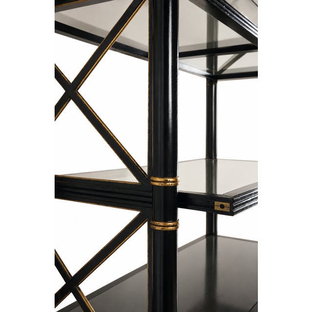 Black Empire Etagere with gold accents and case lighting. The item is not marked or signed.
