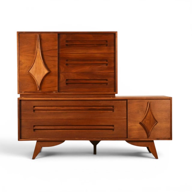 This 1960s Specialty Woodcraft stacking highboy dresser is a rare, eclectic design built as two separate walnut cases....