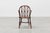 Windsor-style armchair with turned,solid seat. Good, sturdy condition with an old patina to the wood. This fine...