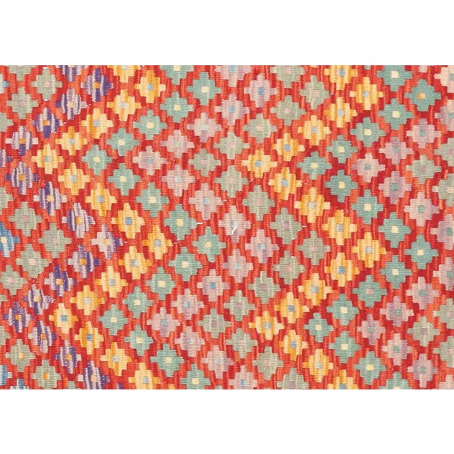 This Vintage Afghan Maimana Kilim, measuring 5'10" by 7'7", is handwoven with wool on a wool foundation by the Maimana...