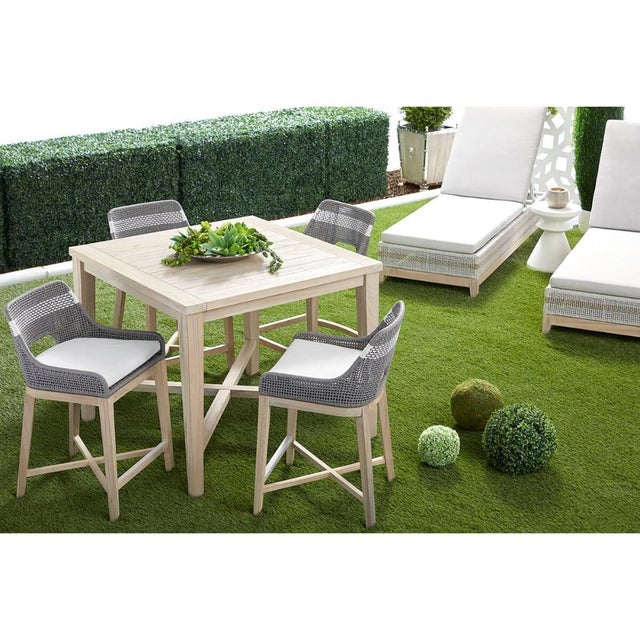 This outdoor counter stool combines coastal-inspired rope weaving with the natural warmth of solid teak, creating a...