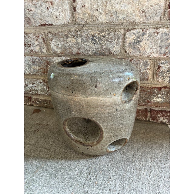 Vintage ceramic vessel with a speckled grey / brown glaze and circular cut out openings throughout. This German Mid-...