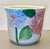 Hand‑painted Italian ceramic planter featuring richly sculpted hydrangea blooms in vibrant pinks and blues. The raised...