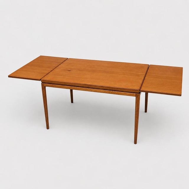 Bring timeless elegance into your home with this beautiful vintage extendable teak dining table. The table is finished in...