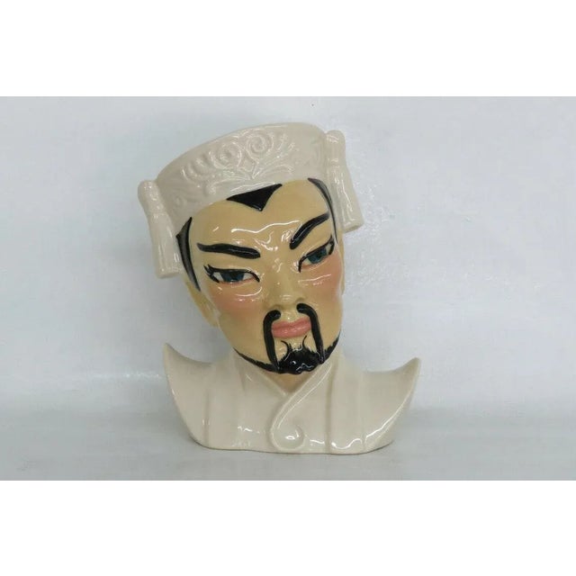 This charming vintage head vase is made of ceramic, and is stamped as being the head vase titled " Manchu " made by...