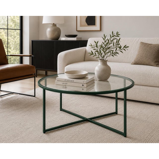 A sleek vintage round coffee table featuring a deep Emerald City green geometric metal frame and clear glass top. Airy,...