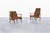 A pair of exquisite mid-century modern teak lounge chairs, crafted in Denmark during the iconic 1960s. These stunning...