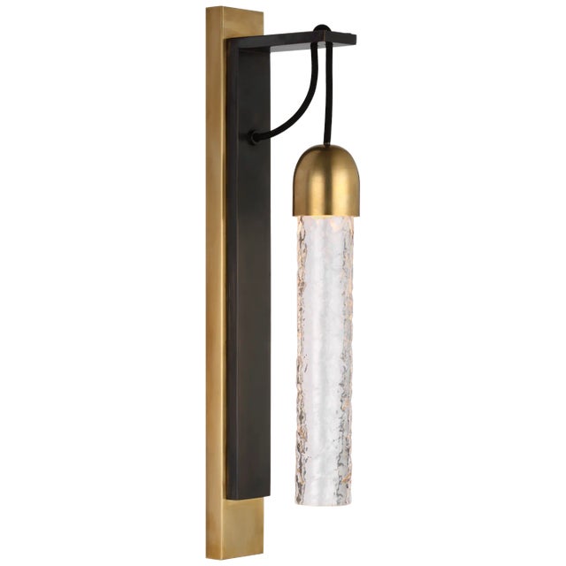 Reve Medium Tube Sconce in Bronze and Soft Brass with Clear Wavy Glass Designer: Marie Flanigan Height: 19" Extension:...