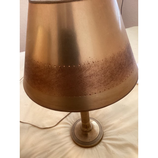 Charming pair of gold colored French style lamps. Beautiful hand made lampshades enhance the candlesticks. These lamps can...