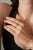 This halo ring is featuring a 0.3 ct oval pink sapphire set in 14K yellow gold. The sapphire measuring 4 x 5 mm as the...