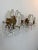 Elegant vintage brass and crystal two-light wall sconces featuring gracefully curved arms adorned with faceted crystal...