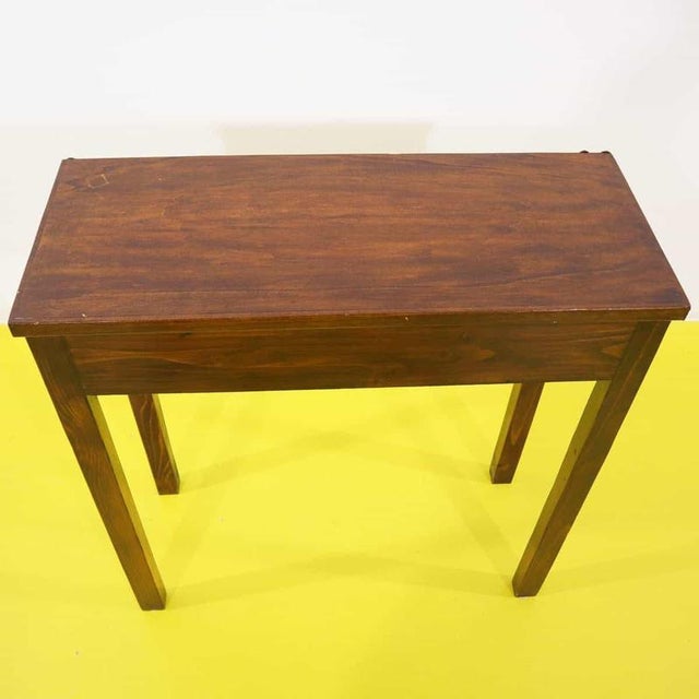 Walnut-stained pine console table featuring straight legs.