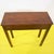 Walnut-stained pine console table featuring straight legs.
